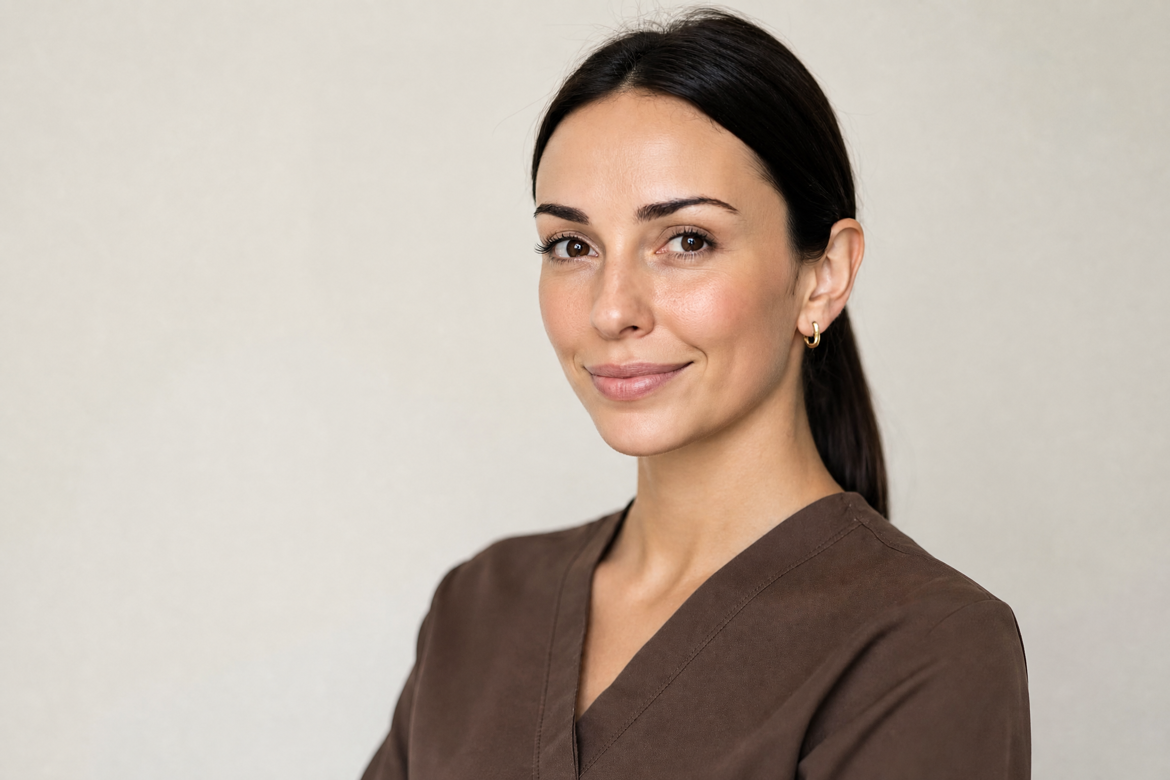 Mia Thomas, Nurse Practitioner, wearing brown scrubs in the Woollahra clinic